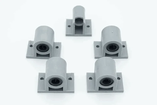 Five grey holders with linear bearings