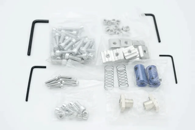 The bag with screws, T-nuts, springs, couplings and Allen keys
