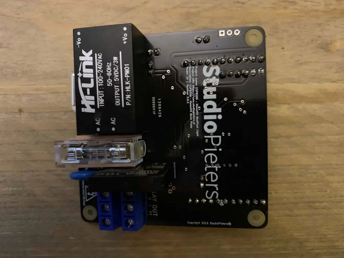 The Hi-Link HLK-PM01 power module, a fuse holder with a fuse and blue screw terminals on the controller board