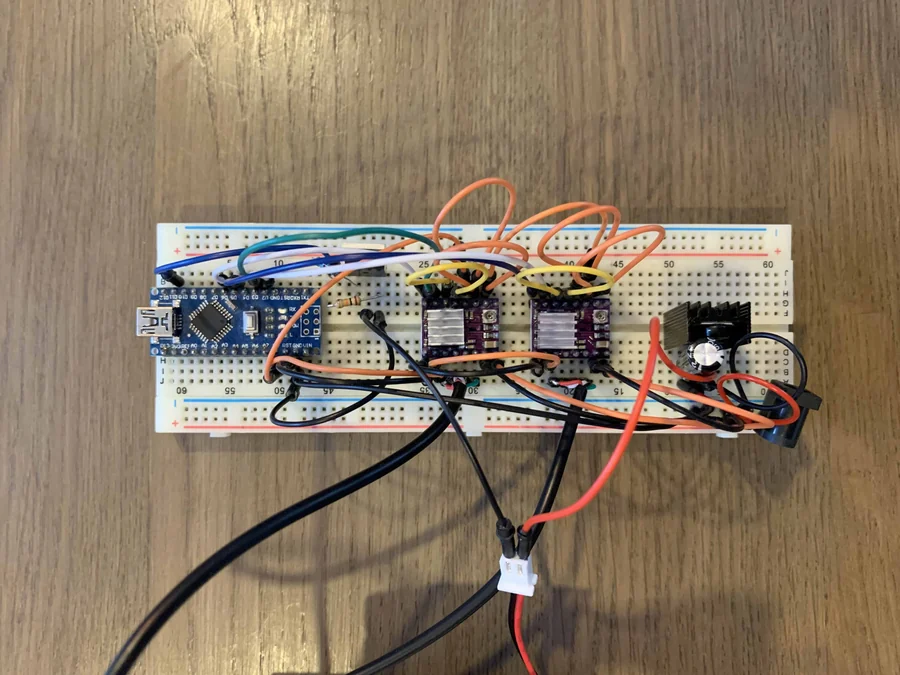 The electronics on a breadboard with an Arduino Nano and wires to the motors
