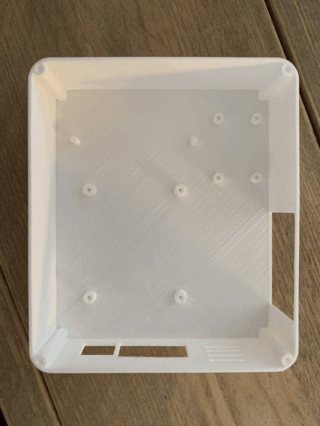 The printed base of the enclosure with small mounting holes